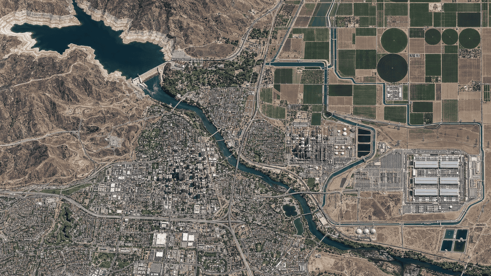 Aerial view of a city, farmland, reservoir, irrigation, industry, and a data center sharing the same water system.
